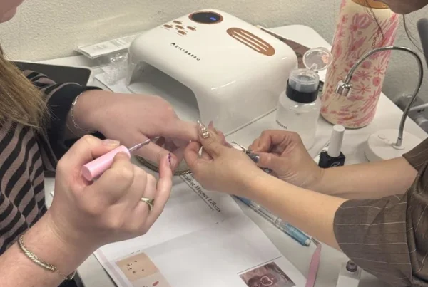 Nail care student practicing detailed nail art at RT7 Beauty College