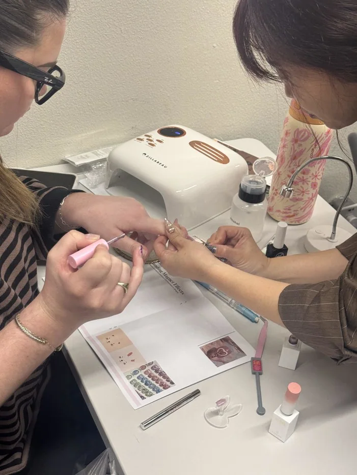 Nail care student practicing detailed nail art at RT7 Beauty College